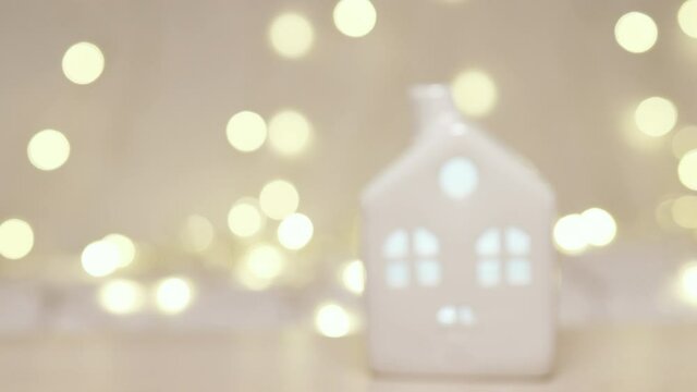 Happy new year 2022 theme with with small toy model house decoration on beautiful gold lights background. Selective focus