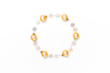 Wreath of golden Christmas baubles, wooden stars and snowflakes against white background. Christmas, winter or new year's arrangement. Flat lay, top view, copy space.