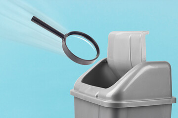 Throw a magnifying glass in the trash, gray bucket on a blue background, concept of a bad search
