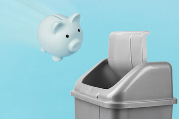 Throw the piggy bank in the trash, gray bucket on a blue background