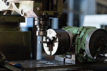 Worker hand working on the milling machine to change metal drill bit. Tool for drilling metal...