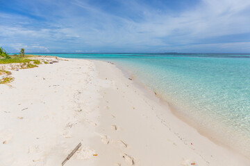 Mantabuan island with turquoise water on a sunny day, Borneo