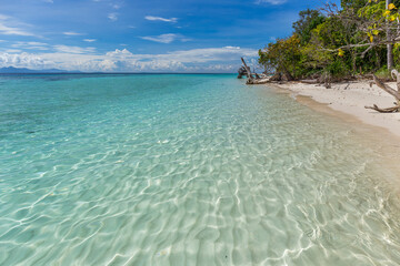 Mantabuan island with turquoise water on a sunny day, Borneo
