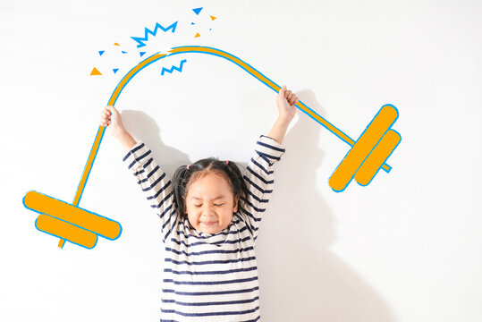 Funny Positive strong Asian little toddler kid girl lifting weight against the textured white background. For empowering women, girl power and feminism, sport, education, and creative future Ideas