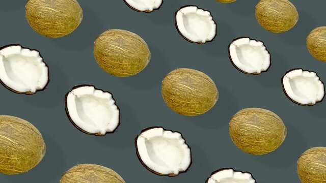 Colorful pattern of coconuts. Top view. Minimal tropical fruit summer concept. Seamless pattern with coconut. Realistic animation. 4K video motion