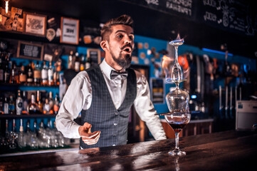Focused bartending makes a cocktail in the nightclub