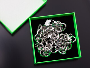 Chain in a green box on a black background.