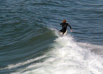 Surfer runs a big Wave at Pacific Beach In California, near Crystal Pier, during December holidays