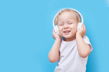 Headphones on the child's head. Listens to music and dances.