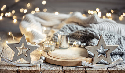 Cozy winter composition with decor details on blurred background with bokeh.