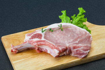 Raw pork bone steak over wooden