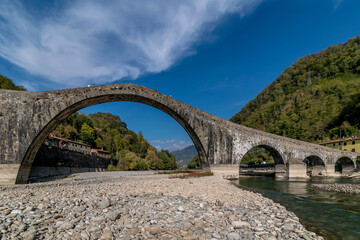 Fototapeta na wymiar The ancient bridge called Ponte del Diavolo or Maddalena, Lucca, Italy, on a sunny day