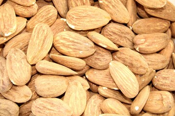 Fototapeta premium close up of a pile of almonds, nuts background