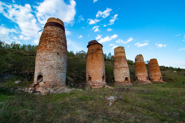Old soviet lime kilns under a cloudy sky on a summer day