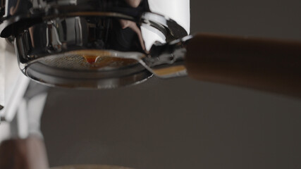 pull espresso shot with bottomless portafilter on a professional coffee machine