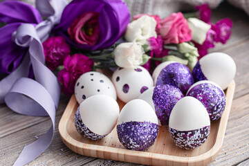Obraz na płótnie Canvas Close-up of Easter eggs decorated with purple sparkles.