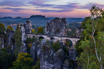 Fototapeta premium Bridge Bastei In Saxon Switzerland Germany utumn With Colored Trees sunset