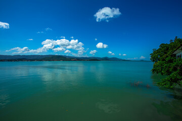 The background of the sea by the evening sea, with natural beauty (sea water, rocks, sky) and fishermen are fishing by the river bank, is a pleasure during travel.