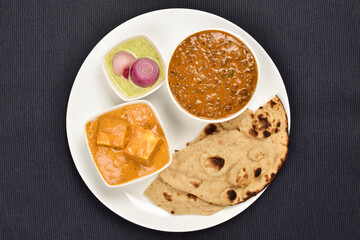 dal makhani shahi panner with roti and chutney pyaz in plate