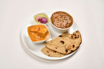 Shahi Paneer and Dal Makhani Served with Tandoori Roti and chutney pickled Onion in Plate