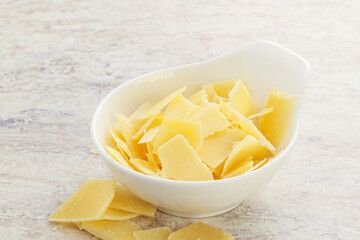 Sliced parmesan cheese heap in the bowl