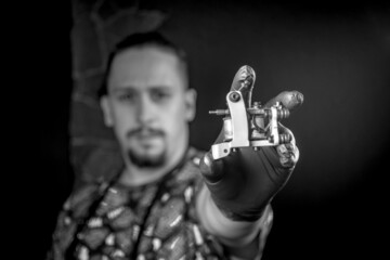 Tattooer poses for the camera in tatoo salon