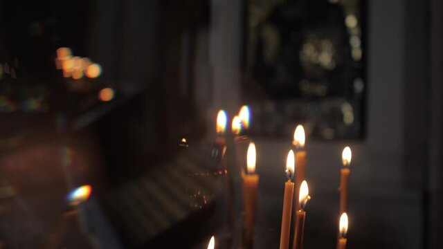Burning candles in the church church. Close-up. High quality FullHD footage