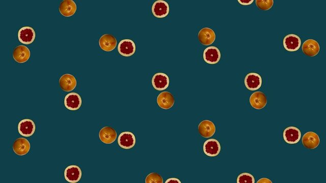 Colorful fruit pattern of fresh rotating grapefruits. Seamless pattern with grapefruit slices. Realistic animation. 4K video motion