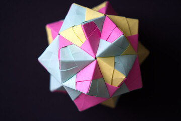 Self-made colorful origami star cube against black background. Photo taken December 26th, 2021, Zurich, Switzerland.