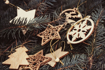 Christmas toys, wooden, on the branches of a Christmas tree, photo indoors with light