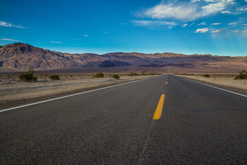 Fototapeta na wymiar Long desert highway leading into Death Valley National Park