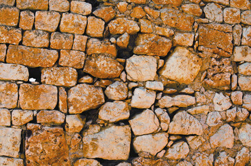 Kizkalesi,Turkey-October 11,2021:Acient brick wall. Grunge brick wall background. Background of old vintage brick wall. Outdoor and indoor interiors. Kanlidivane ancient city in Mersin Province
