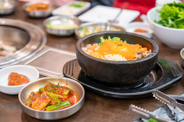 Korean food, Bibimbap in a heated stone bowl, Rice mixed with vegetables, meat, an egg, and chili pepper paste