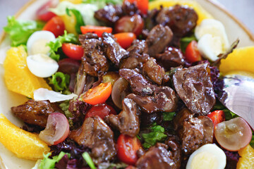 pieces of roasted meat on fresh vegetables with quail eggs. 