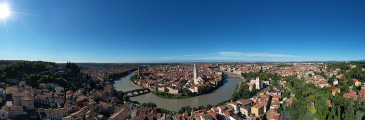Fototapeta na wymiar Aerial panorama of Verona, Italy. Historic Italian town panorama top view. Panoramic top view of Verona city center. Italian medieval city drone view. Italian churches in the old city aerial view.