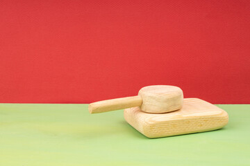 wooden homemade toy tank on wooden floor, background red
