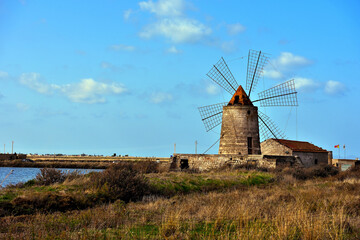 The salt flats with a windmill of Trapani, Sicily (Italy)