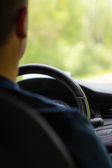 Adult man driving a car. Generic photo of man driving a car through slight turn