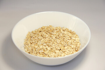 Oatmeal in a white bowl. On a white background.