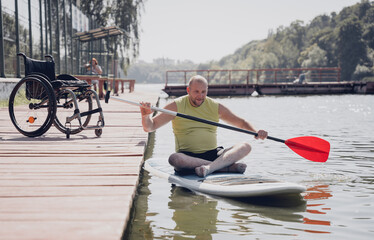 Person with a physical disability ride on sup board