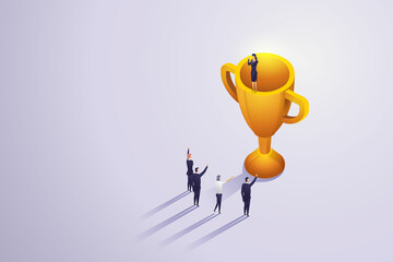 Winning team has businesswoman standing on trophy.
