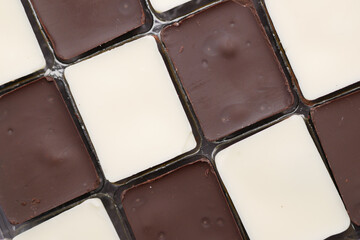 dark and white chocolate in a box on gray background 
