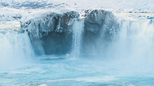 Godafoss, famous waterfall in Iceland, Frozen waterfall in winter, a magical winter location of snow and ice, Pure glacial water with a huge current