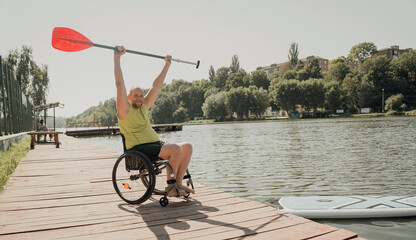 Person with a physical disability who uses wheelchair will be ride on sup board