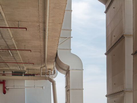 Low Angle View of Vertical White Air Ducts Mounted on the Building