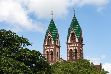Fototapeta na wymiar Twin towers of the Sacred Heart Church Herz-Jesu-Kirche in Freiburg im Breisgau, Baden-Wuerttemberg, Germany