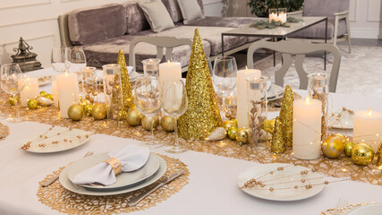 Beautiful table setting with Christmas decorations. Gold colors