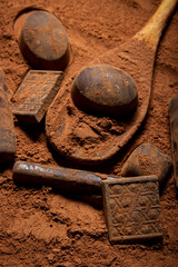 Chocolates lie on cocoa powder. Chocolate making concept. Chocolate sprinkled with cocoa. Cinnamon...