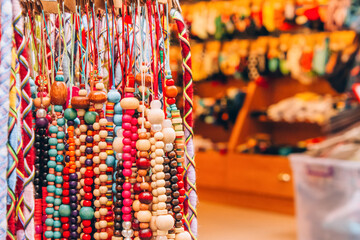 Souvenir stall with variety of colorful souvenirs - wooden beads bracelets and amulets, street...