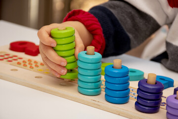 Baby toddler early development. Wooden stack and count rainbow colors learning game. Child learn colors and numbers